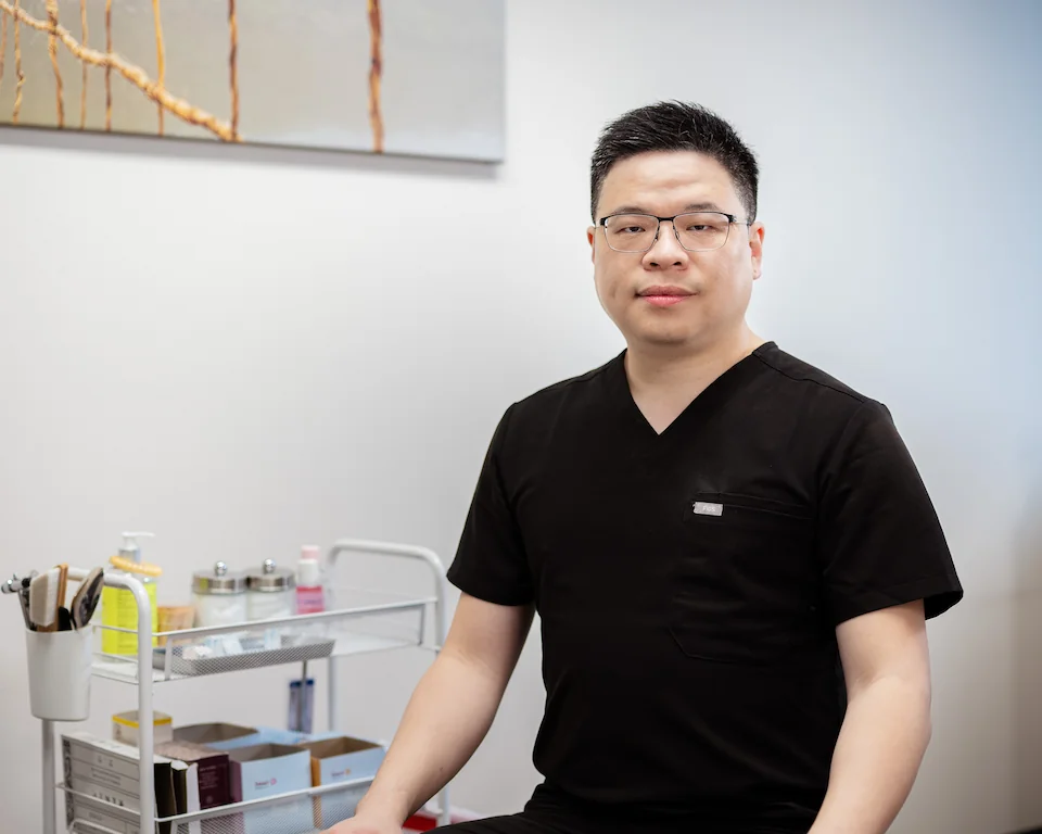 Dr. Ta Shing (Derrick) Yang in the treatment room at Different Acupuncture